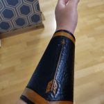 leather arm guard with arrow in yellow and black