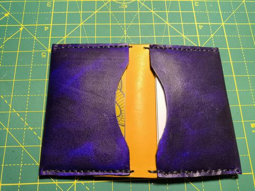 Leather card holder in purple and yellow.