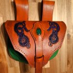 Fantasy leather pouch in brown and green with a green gem and a violet nordic dragon design.