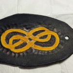 Black leather hairpin with a yellow infinite double loop.