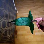 Crafted leather Lorien leaf hairpin in green with a black wooded stick.